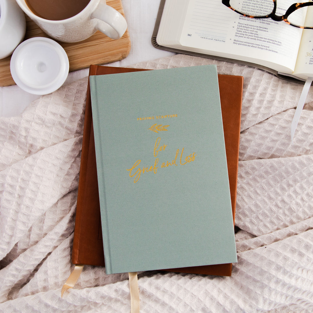 A journal for grief and loss with a green fabric cover