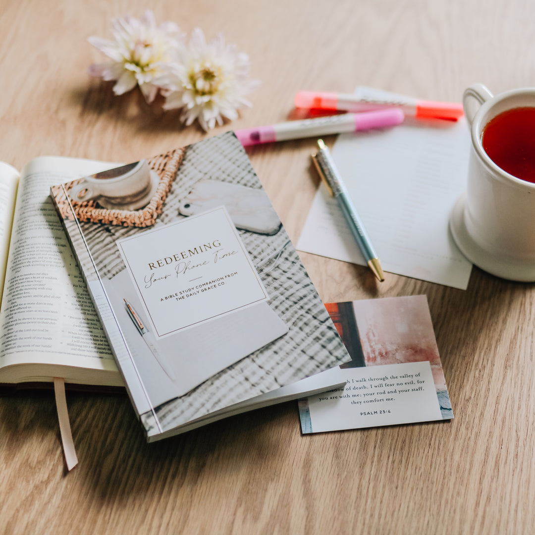 Redeeming Your Phone Time on a table next to verse cards, highlighters, and a cup of tea. 