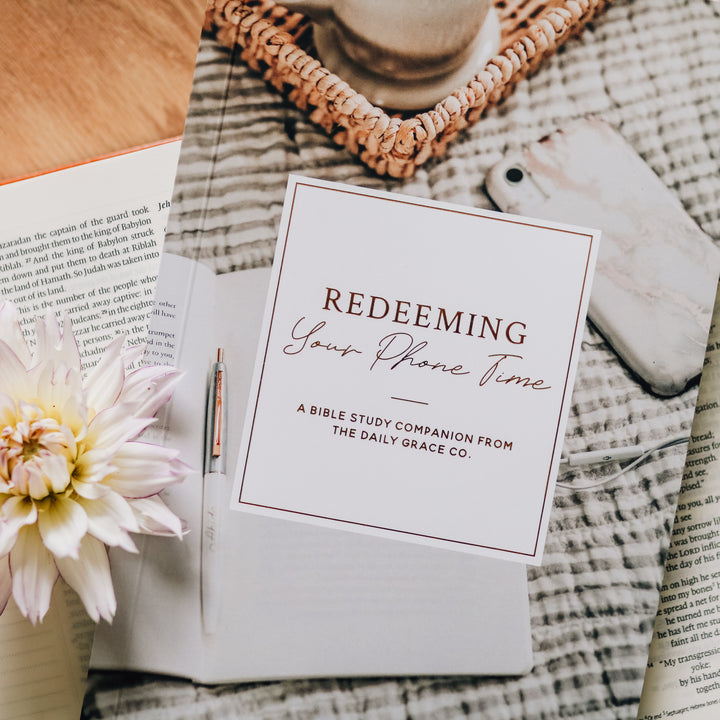 Image of the cover of redeeming your phone time with a flower next to the book.