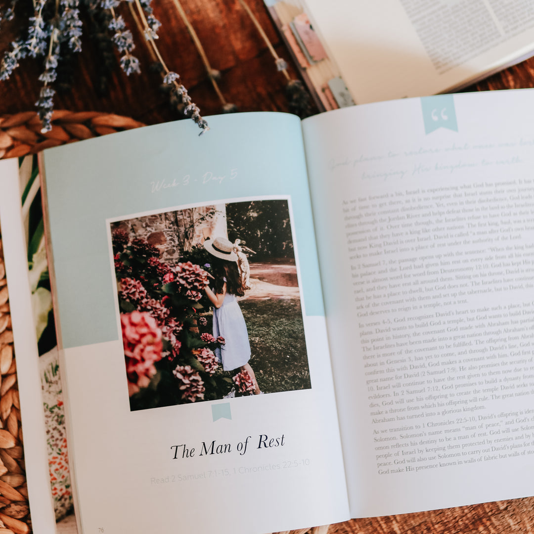 The inside of the Rest Bible Study. The study is open to a picture of a woman standing next to flowers. 