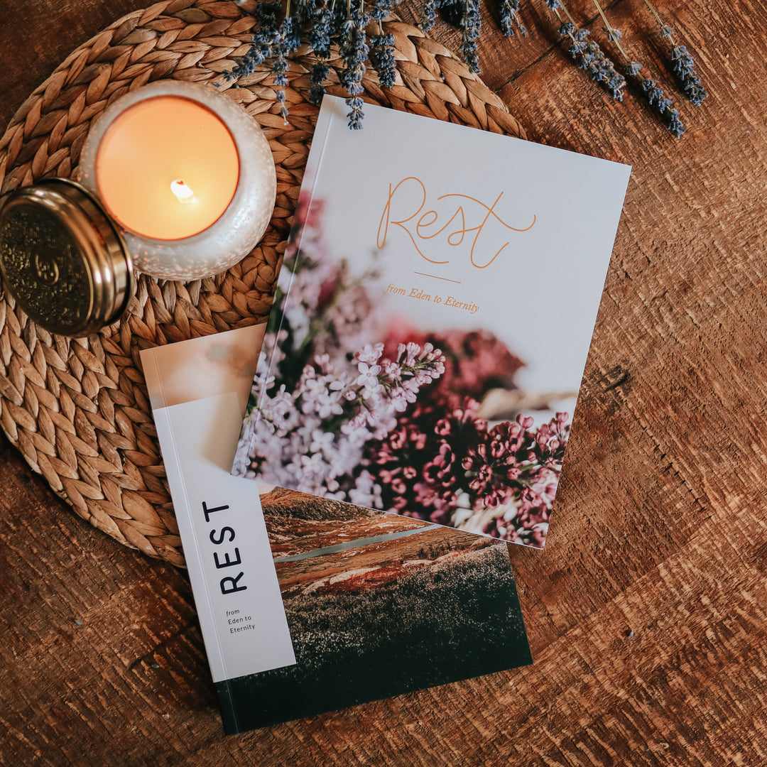 Men's and women's Bible study on Rest next to a lit candel.