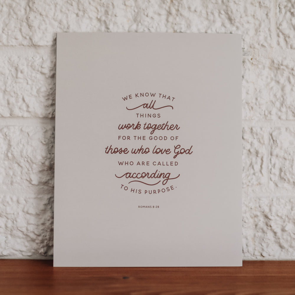 Print of Romans 8:28 on white backing