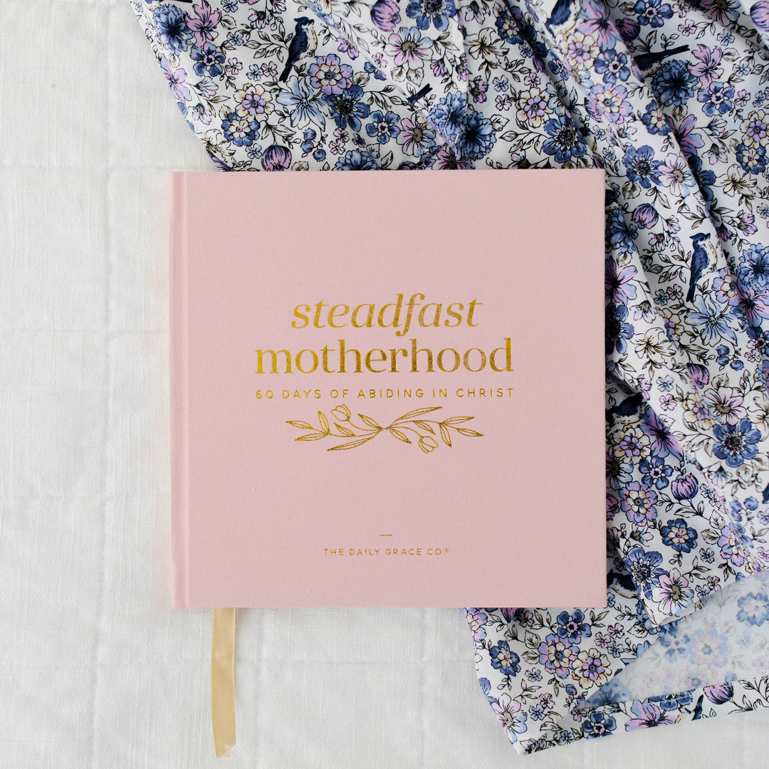 Steadfast Motherhood Devotional showing pink, front cover with gold foil title text.