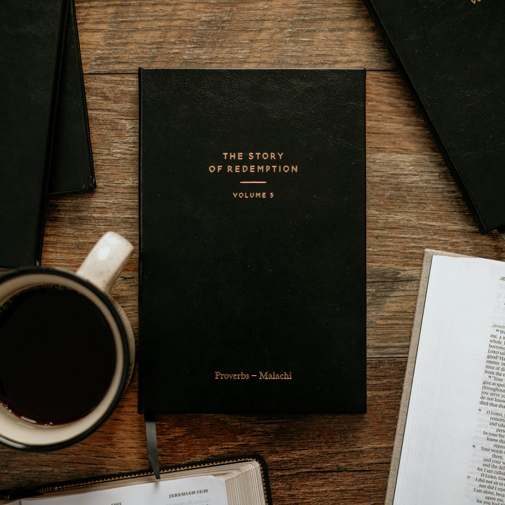 journal laid on table next to coffee mug