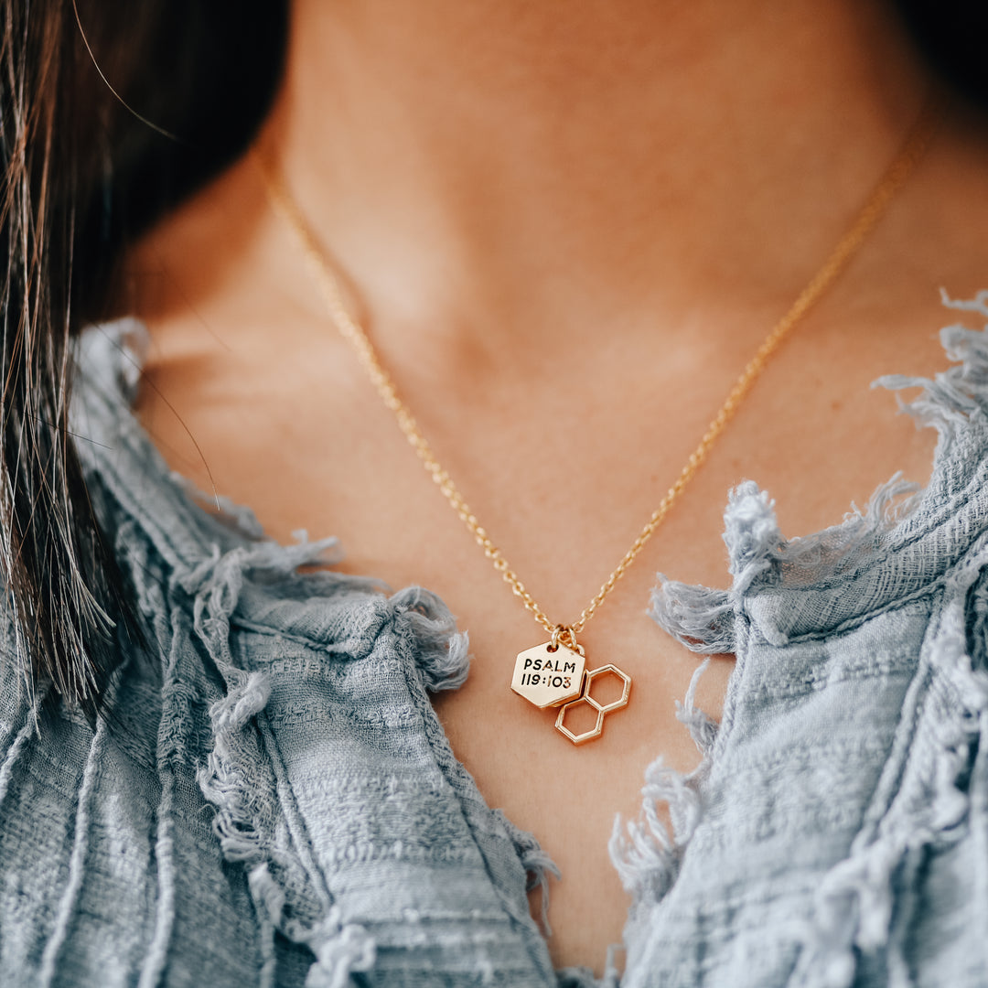 Two gold charms on necklace chain