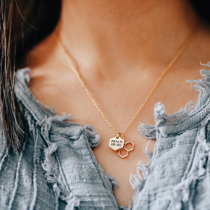 Two gold charms on necklace chain