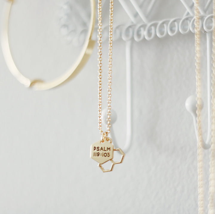 Two gold charms on necklace chain