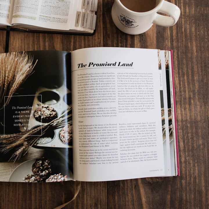 Handbook open on table next to cup of coffee