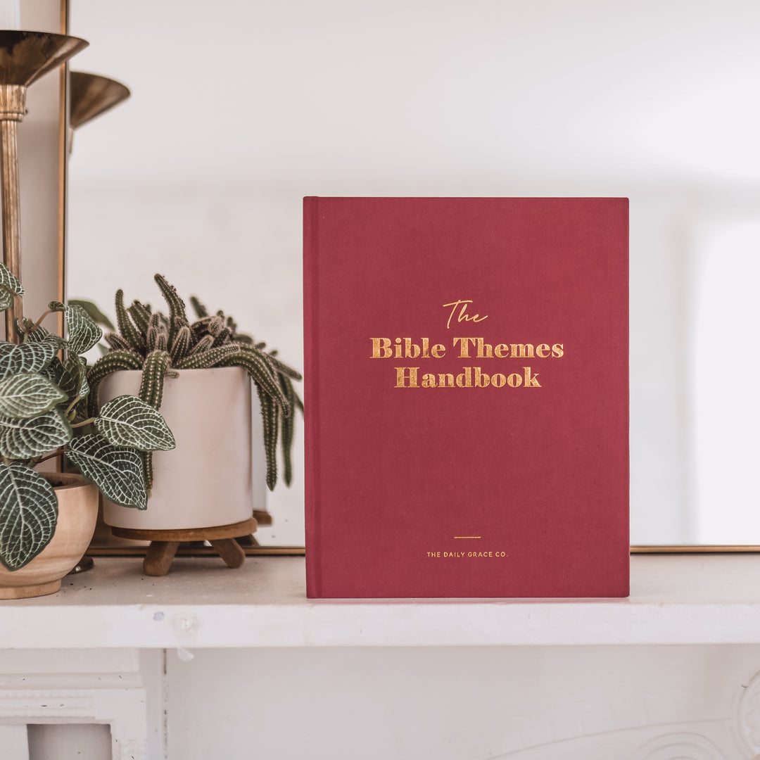 Handbook on shelf showing cover next to plants