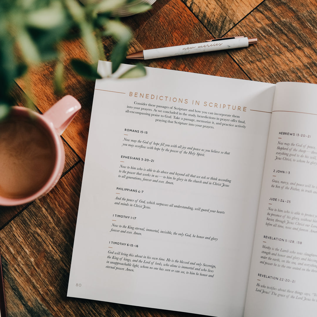 Bible Study open to Benedictions in Scripture page with pen and coffee mug next to it