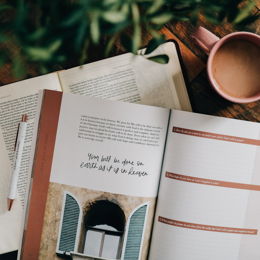 Bible Study open to weekly question pages with coffee mug next to it