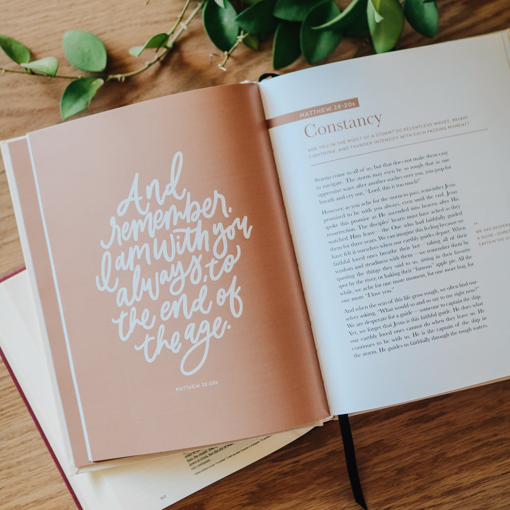 Coffee table book open to page of hand lettered quote