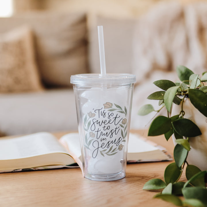 'Tis So Sweet to trust in Jesus Christian Tumbler on table by book