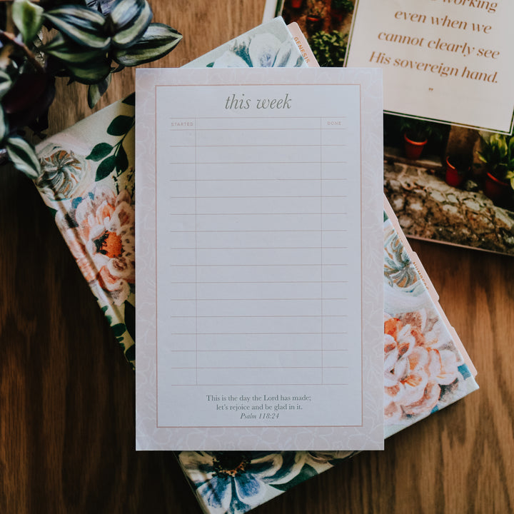 photo of notepad on top of Bible