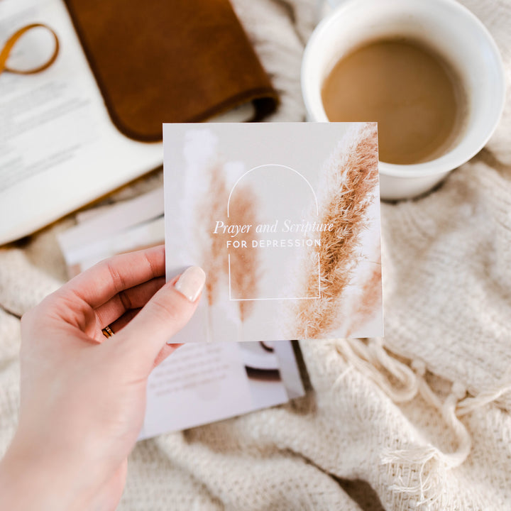 hand holding up a verse card for prayer and scripture for depression