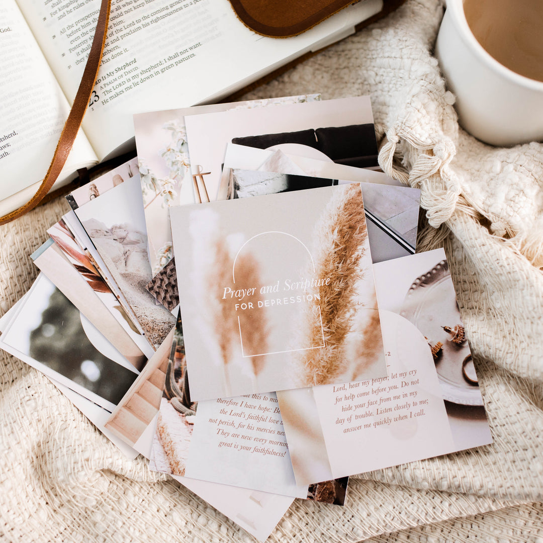 Verse cards for depression on top of blanket next to Bible