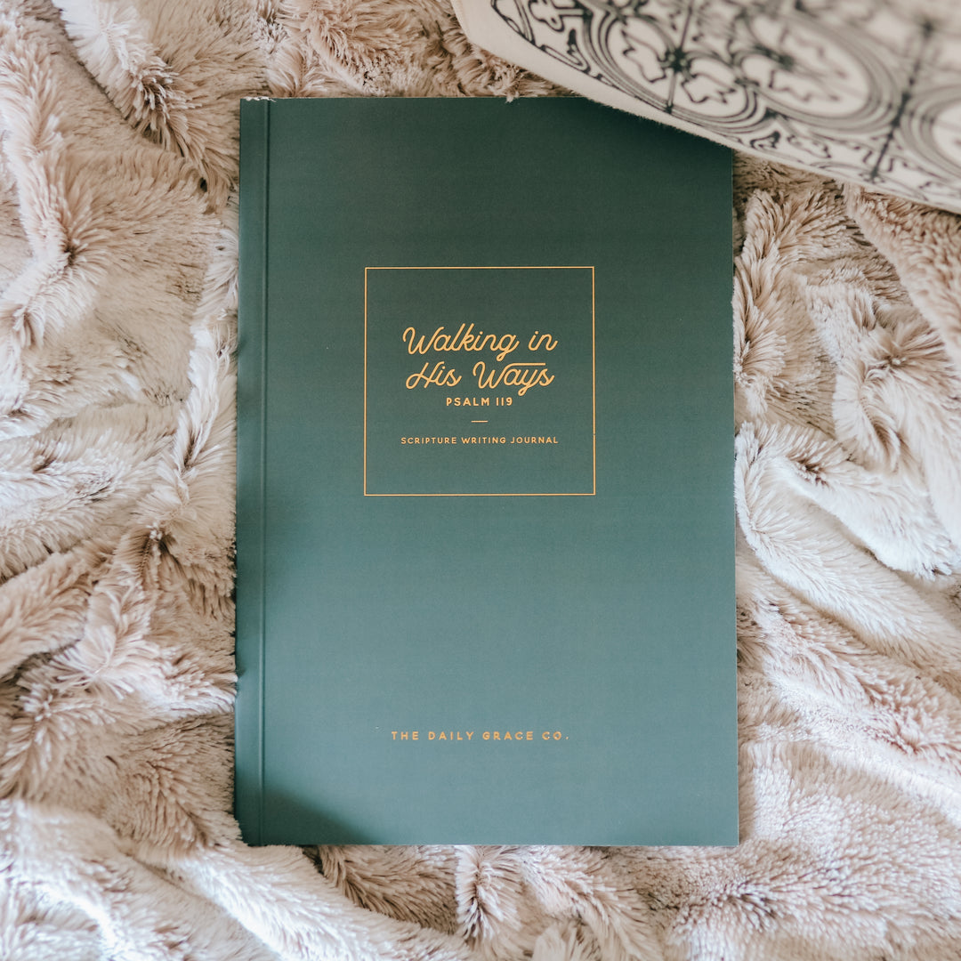 Scripture writing journal sitting on blanket