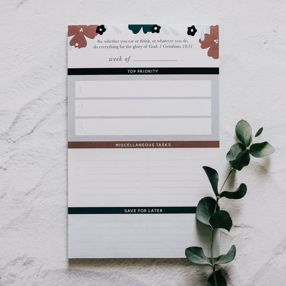 notepad for women to keep track of weekly tasks sitting on table