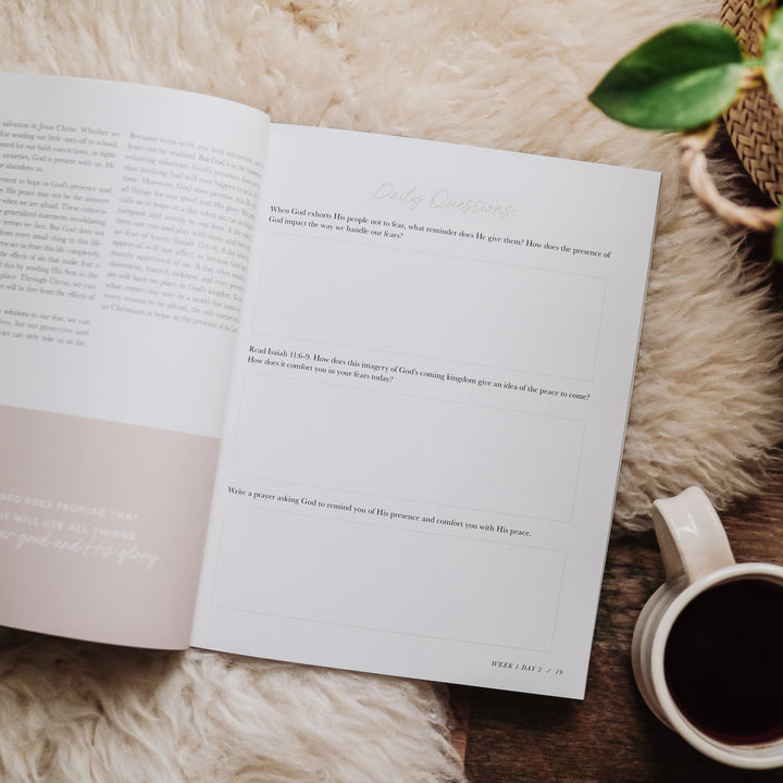 Bible Study for fear sitting open on rug