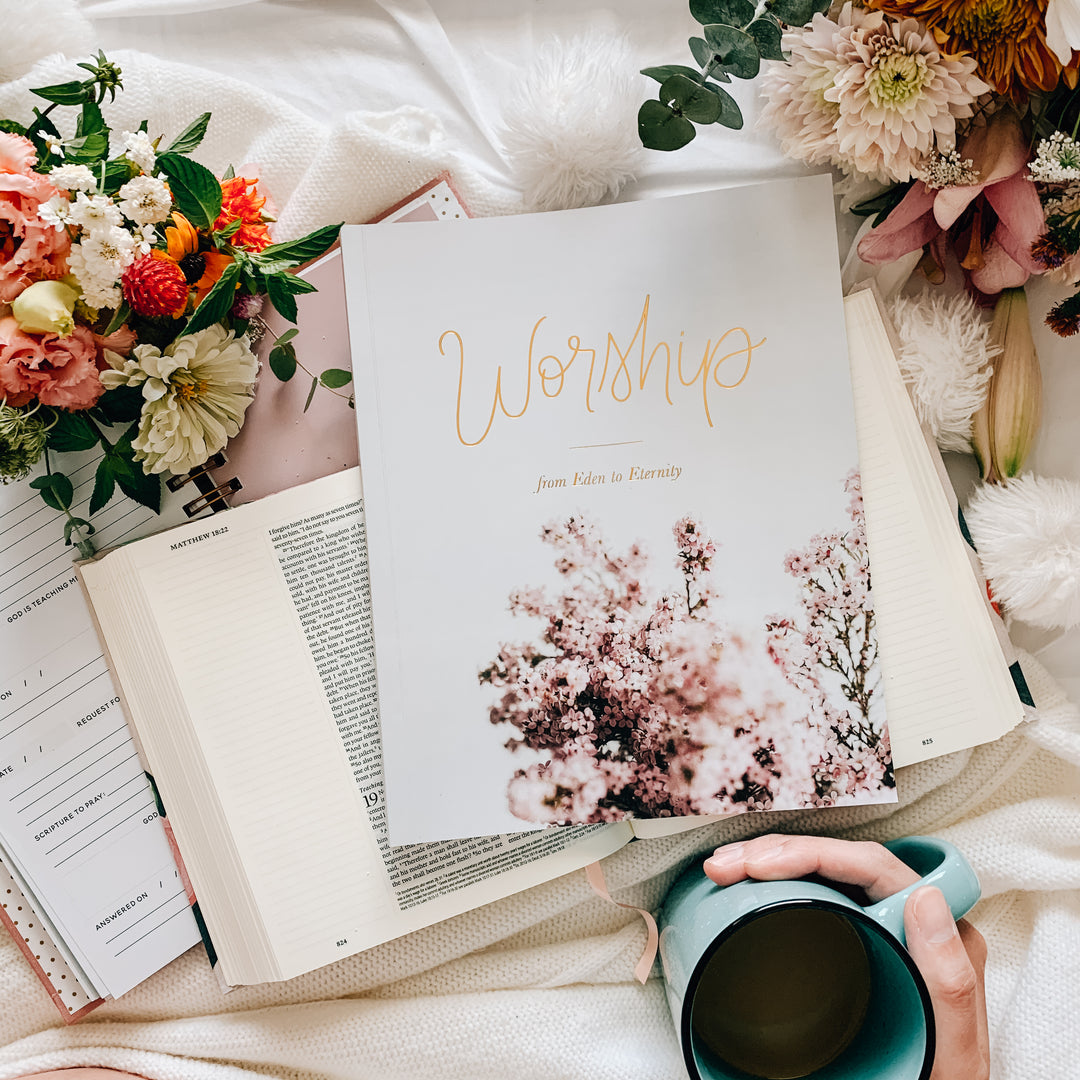 women's Bible Study on worship sitting on Bible next to mug