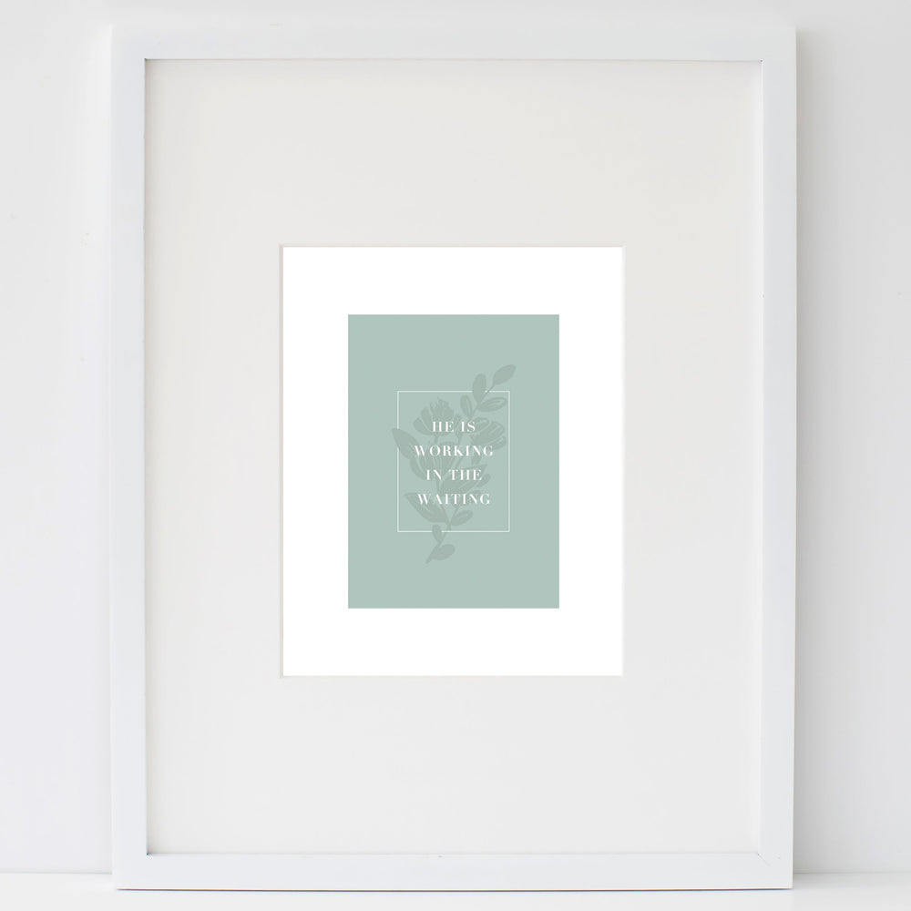 In the Waiting print in a white frame leaning on a white wall