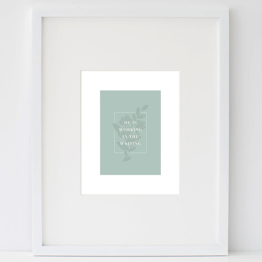 In the Waiting print in a white frame leaning on a white wall