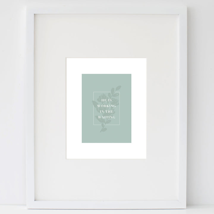In the Waiting print in a white frame leaning on a white wall